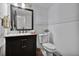 Well-lit half bathroom with a stylish black vanity and marble countertop with fresh white paint for a modern look at 105 Carter Dr, Goose Creek, SC 29445