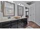 Bathroom featuring dual vanities with dark cabinets, framed mirrors, and modern lighting at 105 Carter Dr, Goose Creek, SC 29445