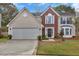 Charming two-story home with a well-maintained lawn, brick and vinyl siding, and an attached two-car garage at 105 Carter Dr, Goose Creek, SC 29445