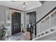 Bright foyer features a decorative pendant light, hardwood floors, and a staircase with white risers and dark handrail at 105 Carter Dr, Goose Creek, SC 29445