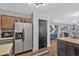 Spacious kitchen with wood and gray cabinets, stainless steel refrigerator and microwave with an eat-in dining area nearby at 105 Carter Dr, Goose Creek, SC 29445