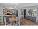 Open-concept kitchen and dining area featuring stylish lighting, gray walls, and wood floors at 105 Carter Dr, Goose Creek, SC 29445