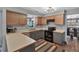 Functional kitchen features wood and gray cabinets, black appliances, and laminate countertops at 105 Carter Dr, Goose Creek, SC 29445