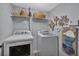 Functional laundry room equipped with modern washer and dryer with wall decorations and storage space at 105 Carter Dr, Goose Creek, SC 29445