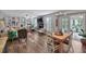 Bright and airy living room featuring hardwood floors, built-in shelves and large windows with access to a screened-in porch at 105 Carter Dr, Goose Creek, SC 29445