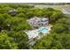 Aerial view of home's outdoor pool and a covered outdoor lounge surrounded by a canopy of lush trees at 1105 Fort Lamar Rd, James Island, SC 29412