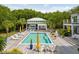 A backyard featuring a pool and a deck with outdoor seating, all surrounded by lush trees at 1105 Fort Lamar Rd, James Island, SC 29412