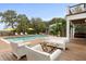 Inviting backyard with a pool, comfortable seating, and mature trees at 1105 Fort Lamar Rd, James Island, SC 29412
