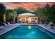 Backyard pool featuring lush landscaping and deck chairs at sunset at 1105 Fort Lamar Rd, James Island, SC 29412