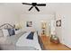 Comfortable bedroom with decorative pillows, a stylish ceiling fan, and an ensuite bathroom at 1105 Fort Lamar Rd, James Island, SC 29412