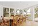 Elegant dining room with large windows, a wooden table, and views of the marsh at 1105 Fort Lamar Rd, James Island, SC 29412