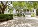 Large circular driveway leading to a home with a multi-car garage, mature trees, and lush landscaping at 1105 Fort Lamar Rd, James Island, SC 29412