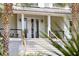 A home's modern front entrance with a custom door, striking symmetry, and lovely palm tree accents at 1105 Fort Lamar Rd, James Island, SC 29412
