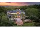 Stunning two-story home featuring palm trees, manicured landscaping, a rooftop terrace and views of the marsh at 1105 Fort Lamar Rd, James Island, SC 29412
