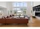 Airy living room with soaring ceilings, fireplace, large windows, and outdoor views of the pool and deck at 1105 Fort Lamar Rd, James Island, SC 29412