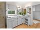Bright bathroom with a large mirror, double sinks, and glass shower at 1105 Fort Lamar Rd, James Island, SC 29412