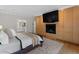 Comfortable main bedroom with hardwood floors, a fireplace, built-in cabinetry, and a view to the bathroom at 1105 Fort Lamar Rd, James Island, SC 29412