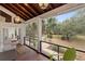 A covered porch with a wood ceiling, ample seating, and gorgeous views of the landscaped yard at 1105 Fort Lamar Rd, James Island, SC 29412
