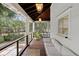 Inviting covered porch with outdoor seating, wood floors, and view of landscaped yard at 1105 Fort Lamar Rd, James Island, SC 29412