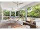 Cozy screened porch with comfortable seating, ceiling fans, and serene views of the lush backyard at 1105 Fort Lamar Rd, James Island, SC 29412