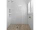 Walk-in shower with white tiled walls, mosaic tile floor, and a handheld shower head at 1105 Fort Lamar Rd, James Island, SC 29412