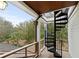 Outdoor covered deck with metal spiral staircase leading to upper level of house at 1105 Fort Lamar Rd, James Island, SC 29412