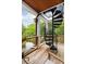Covered deck with metal spiral staircase to upper level and wood railing at 1105 Fort Lamar Rd, James Island, SC 29412
