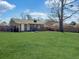 Lush backyard with a grey brick house, basketball hoop, green grass, and a fence surrounding the property at 115 O'Carroll St, Moncks Corner, SC 29461