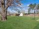 Spacious backyard featuring a storage shed, basketball hoop, and swing amongst the mature trees at 115 O'Carroll St, Moncks Corner, SC 29461