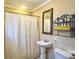 Bathroom with pedestal sink, tiled shower, and classic fixtures at 115 O'Carroll St, Moncks Corner, SC 29461