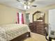 Bedroom with warm carpet, ceiling fan, and a large wooden bed at 115 O'Carroll St, Moncks Corner, SC 29461