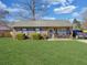 Inviting brick home with a covered porch, manicured bushes, and green lawn at 115 O'Carroll St, Moncks Corner, SC 29461