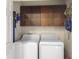 Efficient laundry room with washer, dryer, overhead cabinets, and a vacuum cleaner at 115 O'Carroll St, Moncks Corner, SC 29461