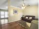 Comfortable living room with a leather sofa, ceiling fan, and hardwood floors at 115 O'Carroll St, Moncks Corner, SC 29461