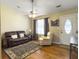 Inviting living room with a leather sofa, hardwood floors, and ceiling fan at 115 O'Carroll St, Moncks Corner, SC 29461