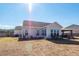Backyard of the home with a patio and surrounding green space at 121 Lakelyn Rd, Moncks Corner, SC 29461