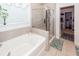 Bathroom featuring a soaking tub, glass-enclosed shower, and tile flooring at 121 Lakelyn Rd, Moncks Corner, SC 29461