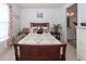 Charming bedroom with a wooden bed frame, carpet, and a view into the bathroom at 121 Lakelyn Rd, Moncks Corner, SC 29461
