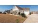 Attractive house showcasing stone accents, a well-manicured lawn, and an attached two-car garage at 121 Lakelyn Rd, Moncks Corner, SC 29461
