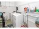Bright laundry room with a modern washer and dryer, storage shelving, and a convenient layout at 121 Lakelyn Rd, Moncks Corner, SC 29461
