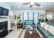 Well-lit living room with fireplace, ceiling fan, and comfortable sofa arrangement at 121 Lakelyn Rd, Moncks Corner, SC 29461