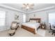 Spacious bedroom with a ceiling fan, bedside table, and natural light from windows at 121 Lakelyn Rd, Moncks Corner, SC 29461