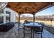 An outdoor dining area with a stone patio and dark metal table with wrought iron chairs at 121 Lakelyn Rd, Moncks Corner, SC 29461