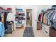 Spacious walk-in closet with shelves, rods for hanging clothes, and a view into the main bedroom at 121 Lakelyn Rd, Moncks Corner, SC 29461
