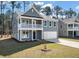 Charming two-story home with a welcoming front porch and well-manicured lawn at 121 Palfrey Dr, Ridgeville, SC 29472