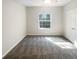 Sunlit bedroom with soft carpeting, a ceiling fan, and bright window overlooking greenery at 1300 Park West Blvd # 420, Mount Pleasant, SC 29466