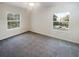 Bright bedroom with soft carpet, ceiling fan, and two windows with outdoor views at 1300 Park West Blvd # 420, Mount Pleasant, SC 29466