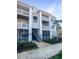 Exterior view of the building with balconies, white railings, and mature landscaping at 1300 Park West Blvd # 420, Mount Pleasant, SC 29466