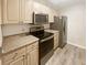 Well-lit kitchen featuring modern appliances and wood cabinetry at 1300 Park West Blvd # 420, Mount Pleasant, SC 29466