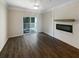 Bright living space with modern electric fireplace, hardwood floors, and a sliding glass door leading to the balcony at 1300 Park West Blvd # 420, Mount Pleasant, SC 29466